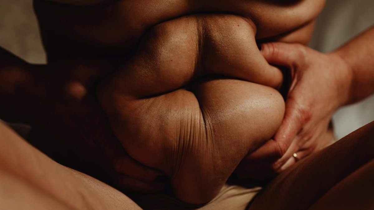 Intimate and close-up shot emphasizing body positivity and self-acceptance.