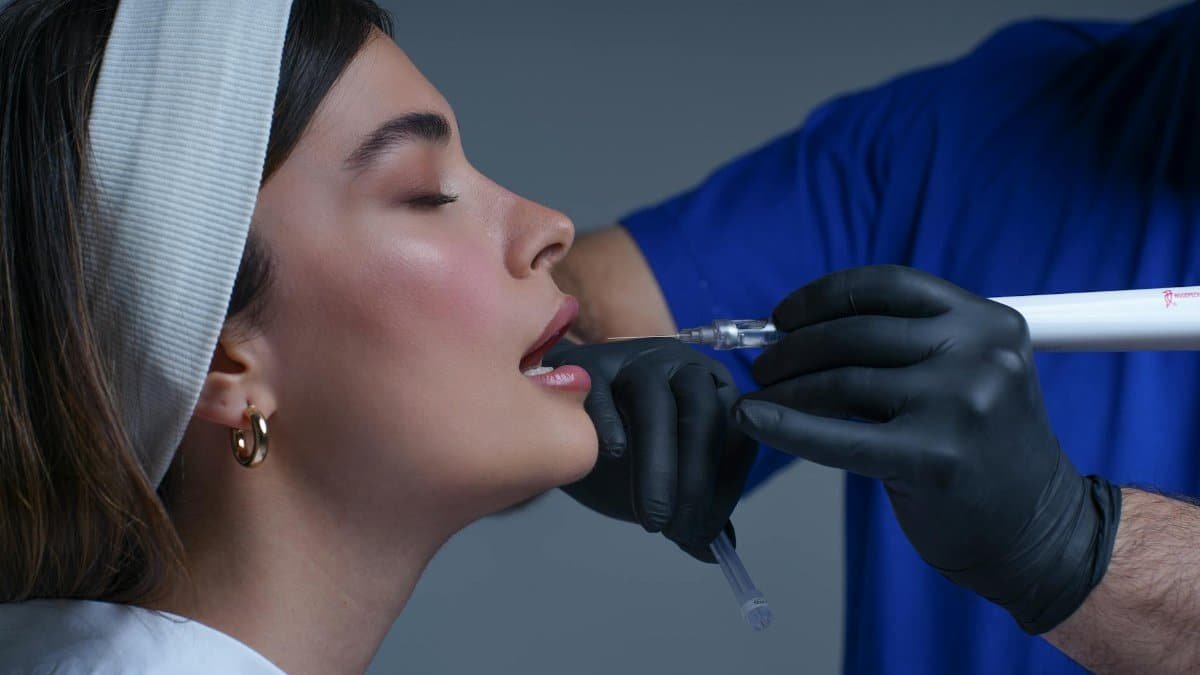 Close-up of a woman receiving a modern cosmetic treatment in a clinical setting.