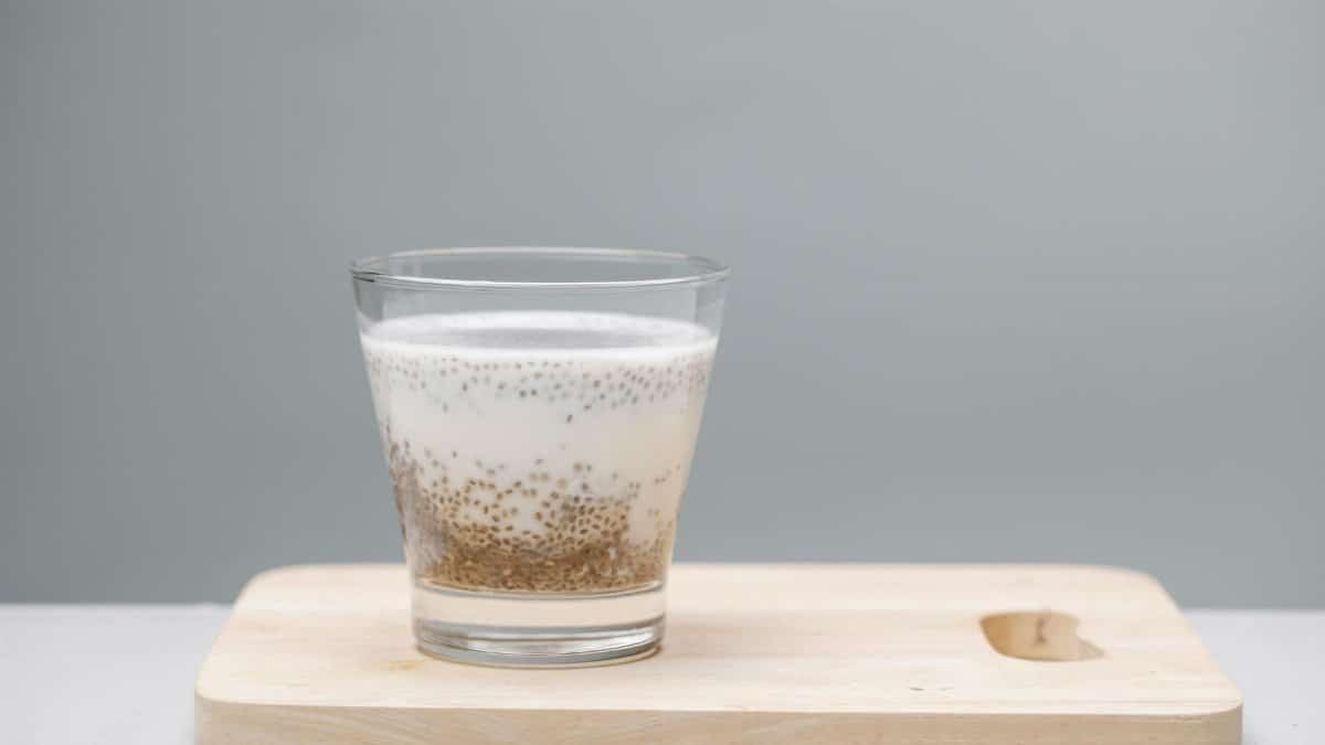 A delicious chia seed pudding in a glass on a wooden board, perfect for a healthy snack.
