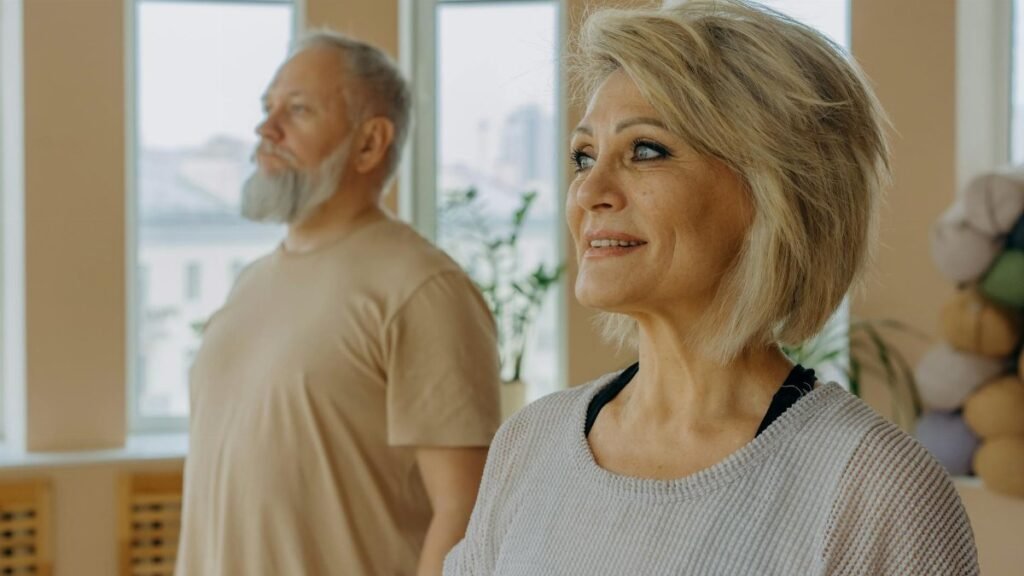 Senior couple at a wellness studio enjoying yoga and relaxation indoors.