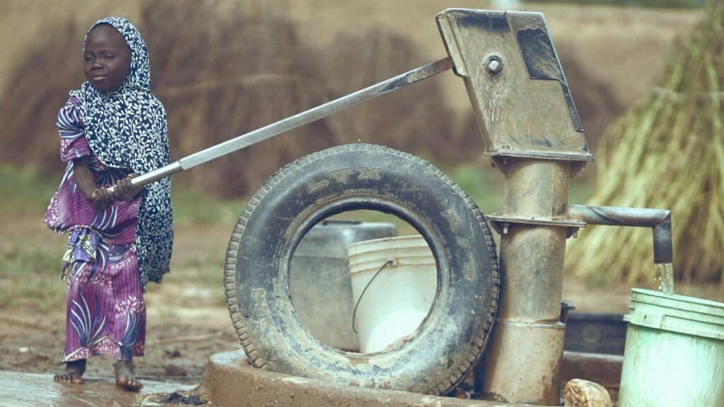 Child fetching water from a well in Katsina, Nigeria, symbolizing rural life.