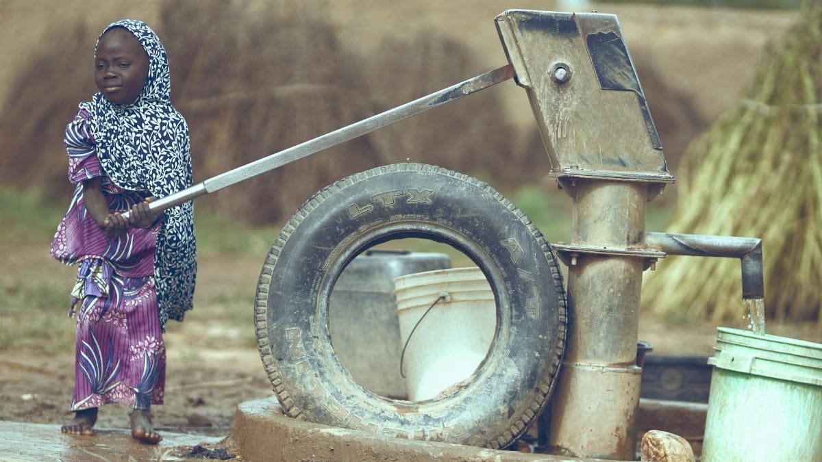 Child fetching water from a well in Katsina, Nigeria, symbolizing rural life.