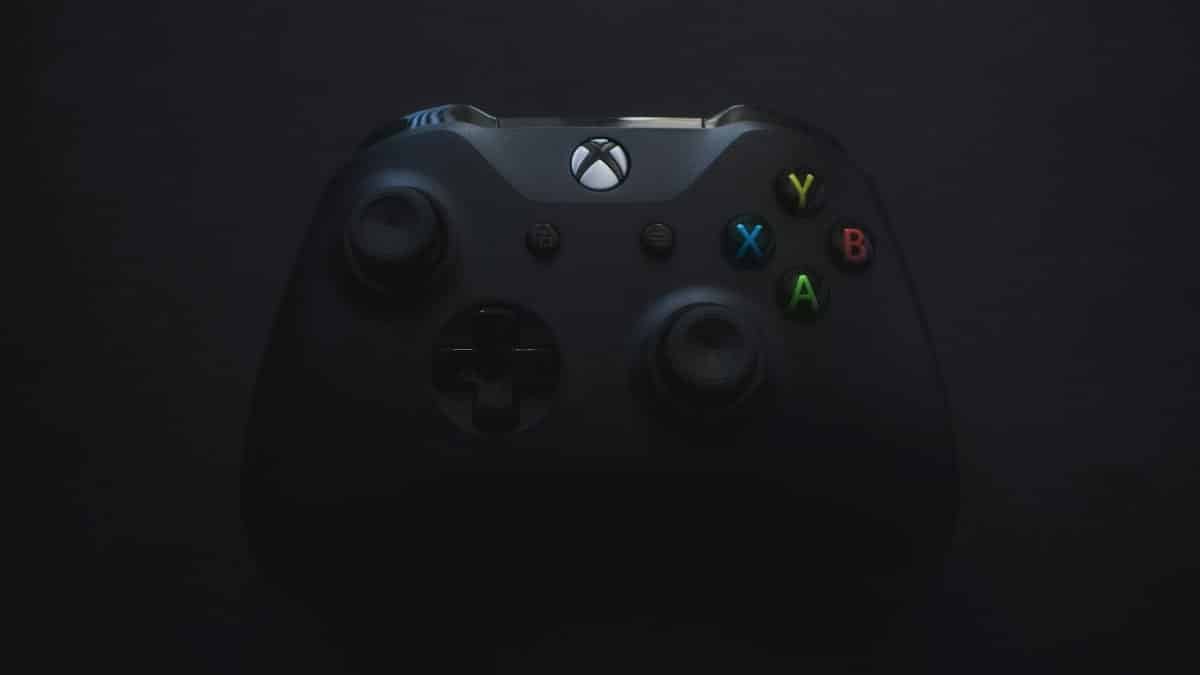 Xbox controller illuminated against a dark background, perfect for gaming themes.