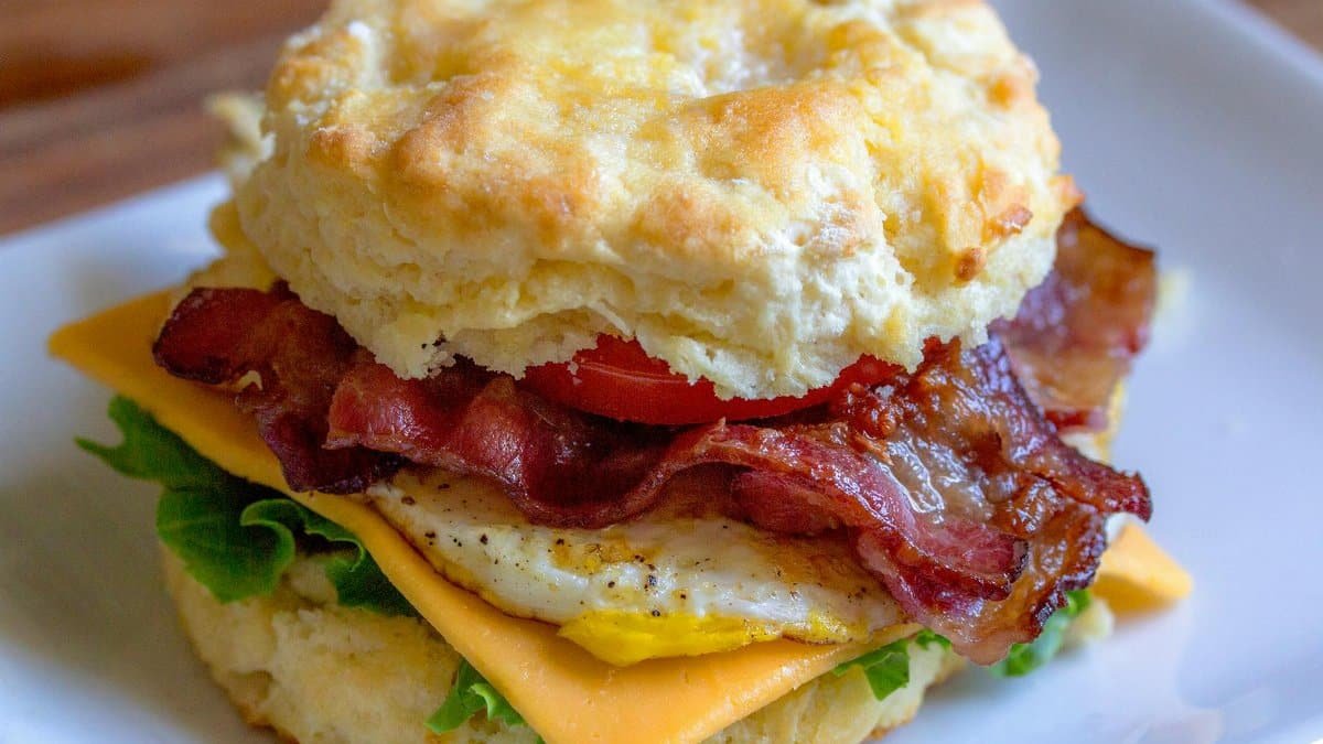 Delicious breakfast biscuit sandwich with bacon, egg, and cheese. Perfect for breakfast lovers.