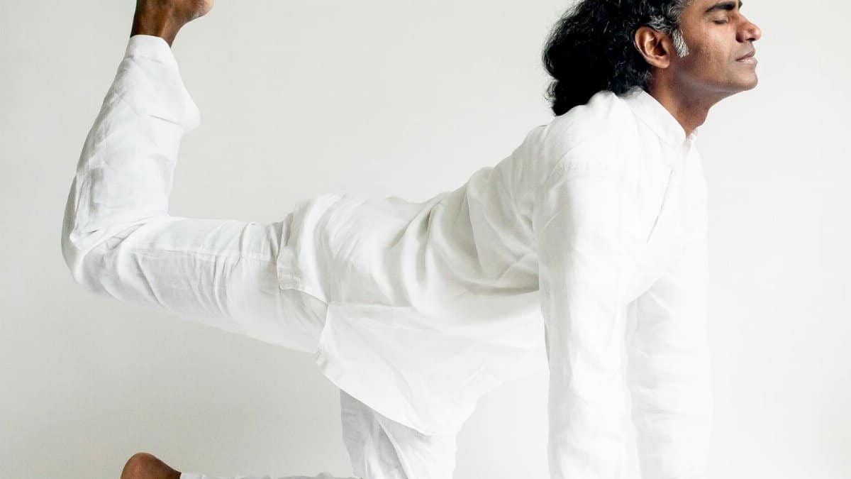 A yogi performing a balanced yoga pose, showcasing calm and concentration.