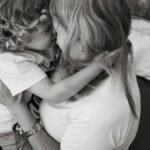 A heartwarming black and white image capturing a mother and child in a loving embrace.