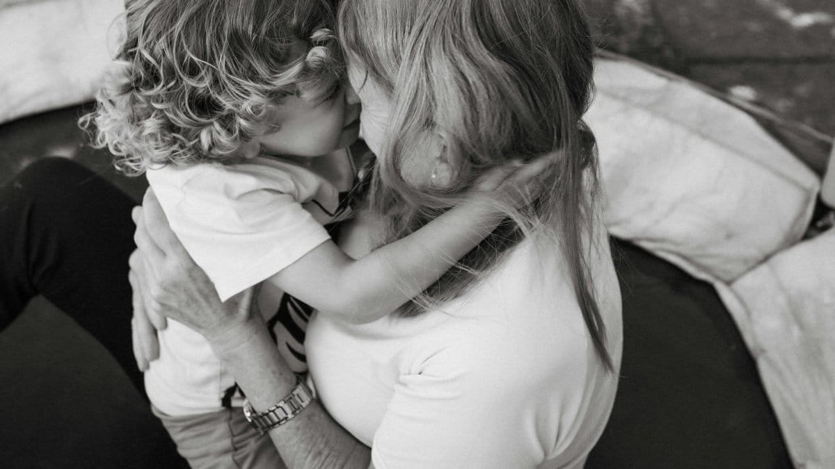 A heartwarming black and white image capturing a mother and child in a loving embrace.