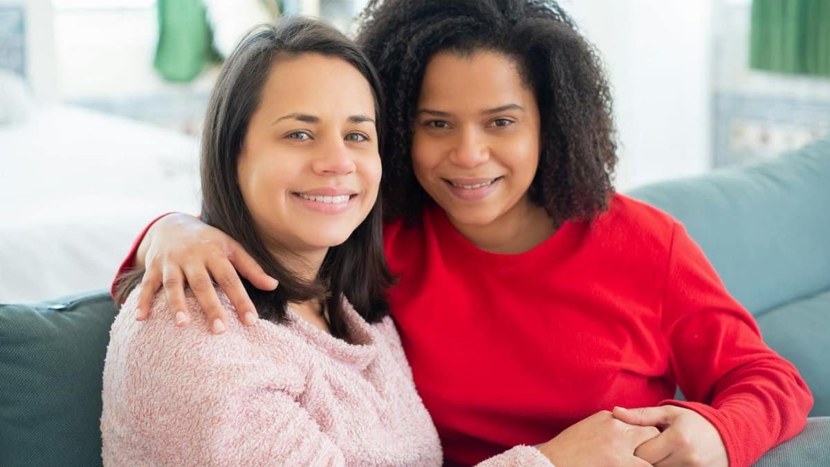 Happy couple at home embracing, showcasing love and affection indoors.