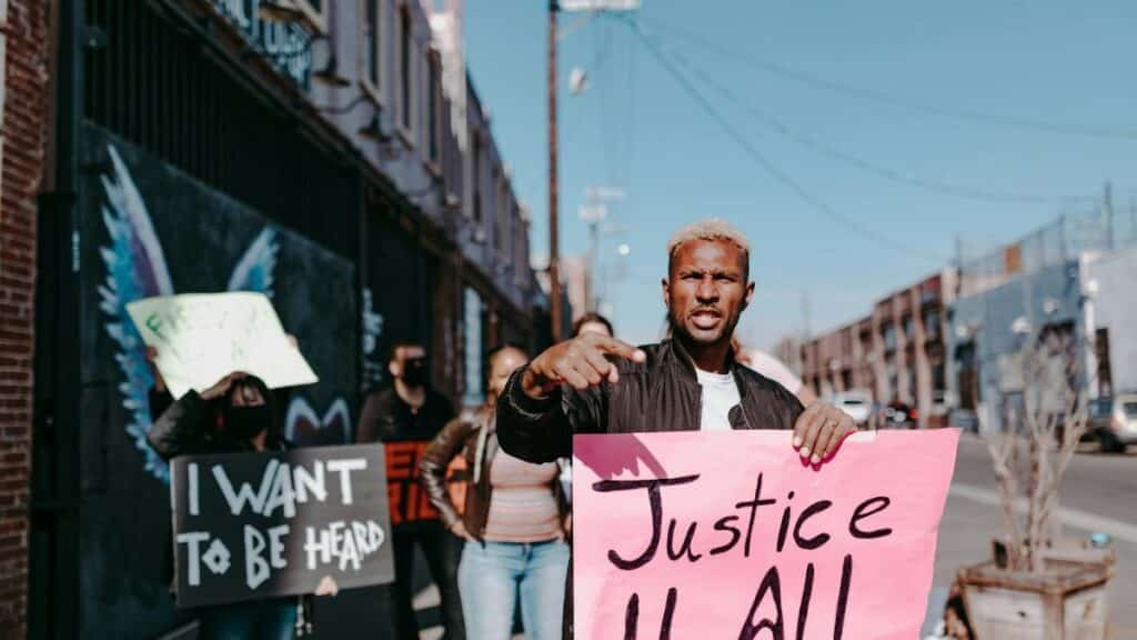 A group of activists holding signs demanding justice during a peaceful protest in the city.