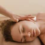 A woman receives a soothing head massage, promoting relaxation and stress relief.