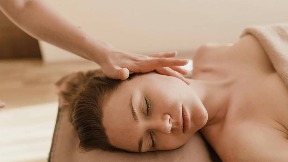 A woman receives a soothing head massage, promoting relaxation and stress relief.