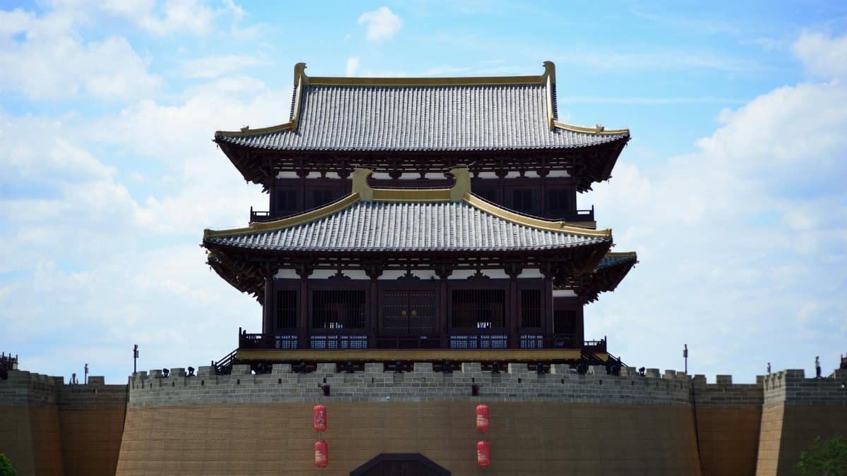 Elegant traditional Chinese building against a vibrant blue sky, showcasing classic architecture.