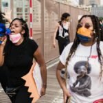 Group of diverse people gathered for a Black Lives Matter protest outdoors in the city.