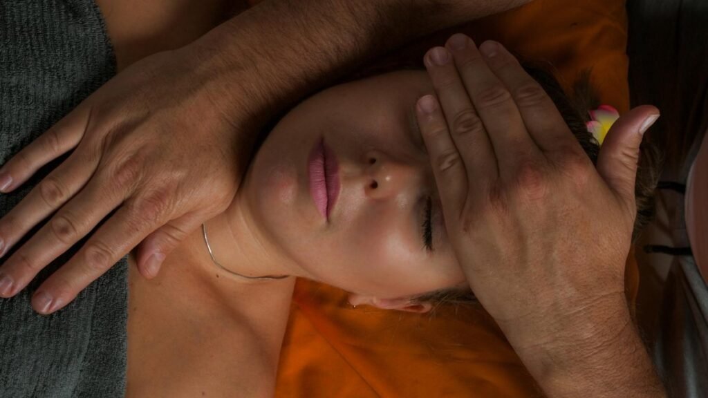 A serene close-up of a woman receiving a reiki massage for ultimate relaxation and wellness.