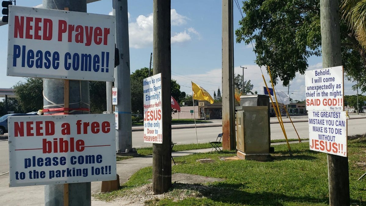 Outdoor religious signs inviting prayer and free bibles in West Palm Beach, Florida.