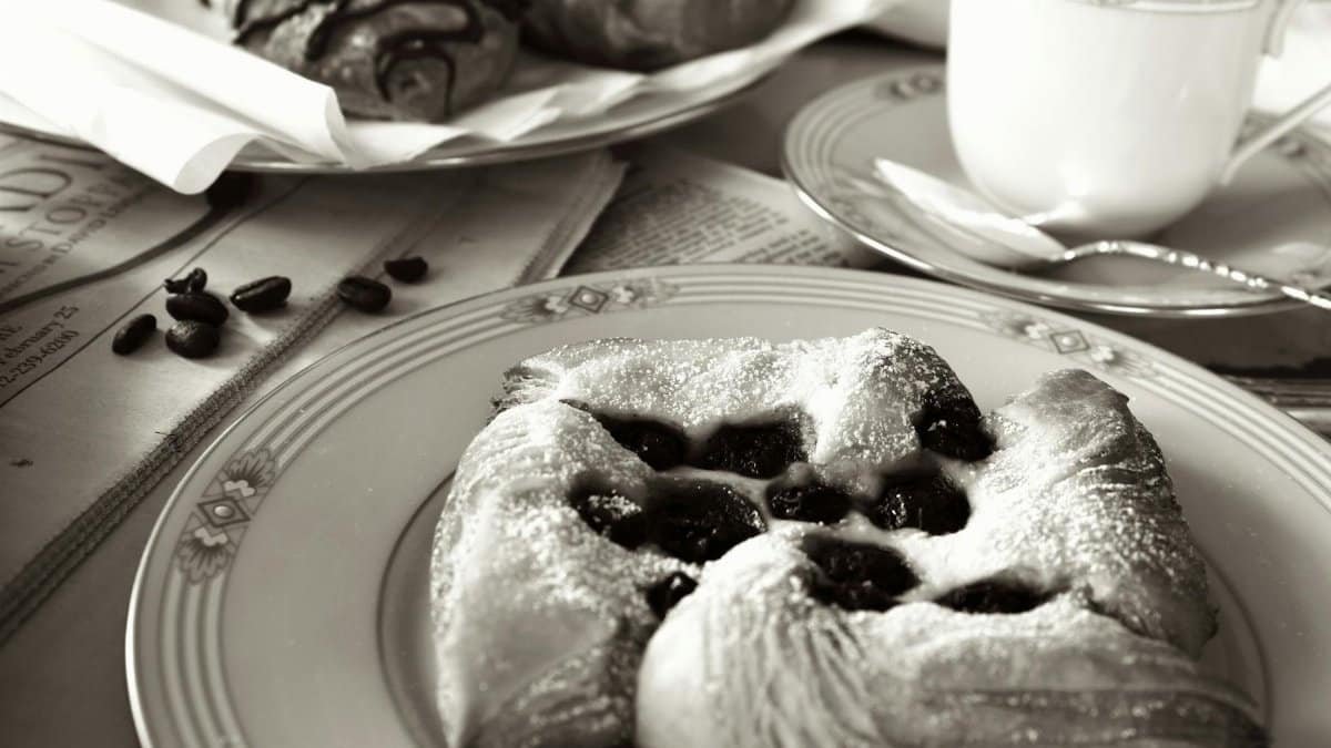 Black and white image of delicious breakfast pastries and coffee, creating a classic morning ambiance.
