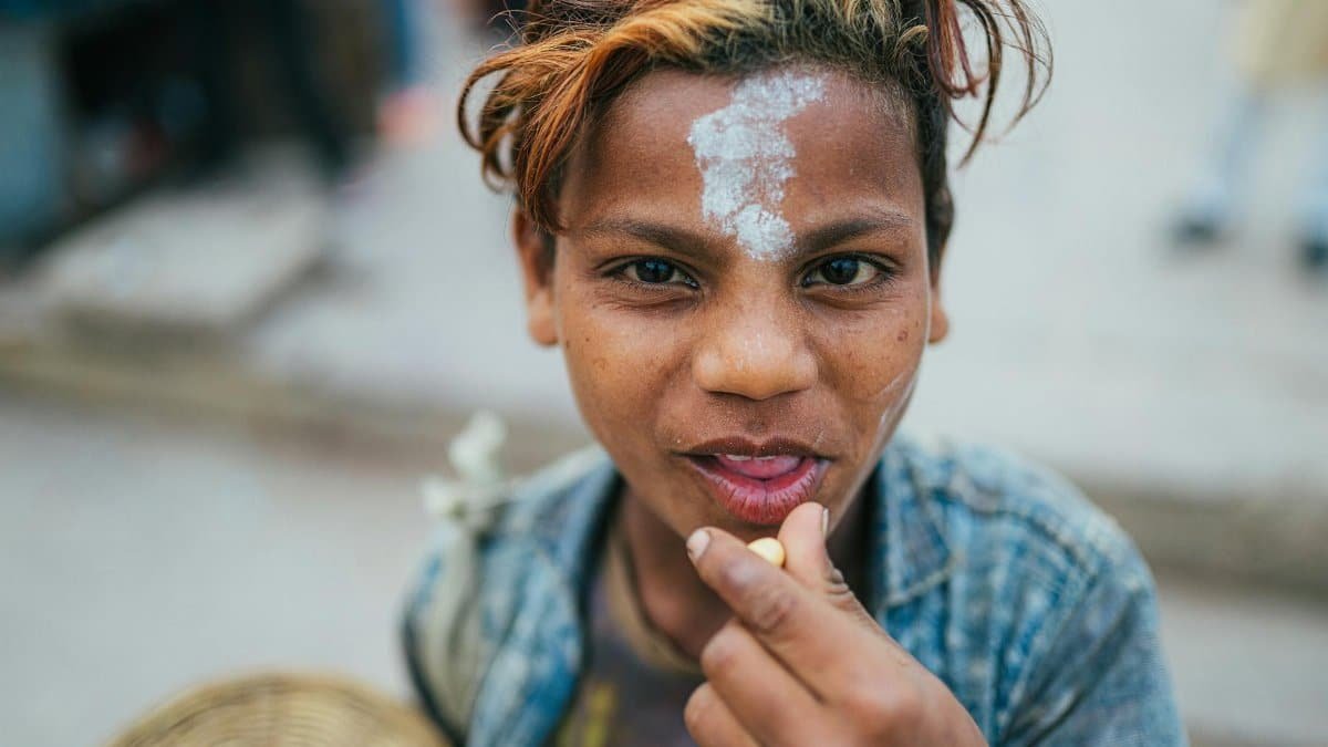 Close-up portrait of a child with face paint in vibrant Varanasi, capturing local culture and emotion.