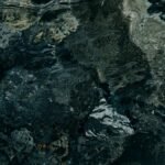 Abstract close-up of rippling dark water creating intricate texture and patterns.