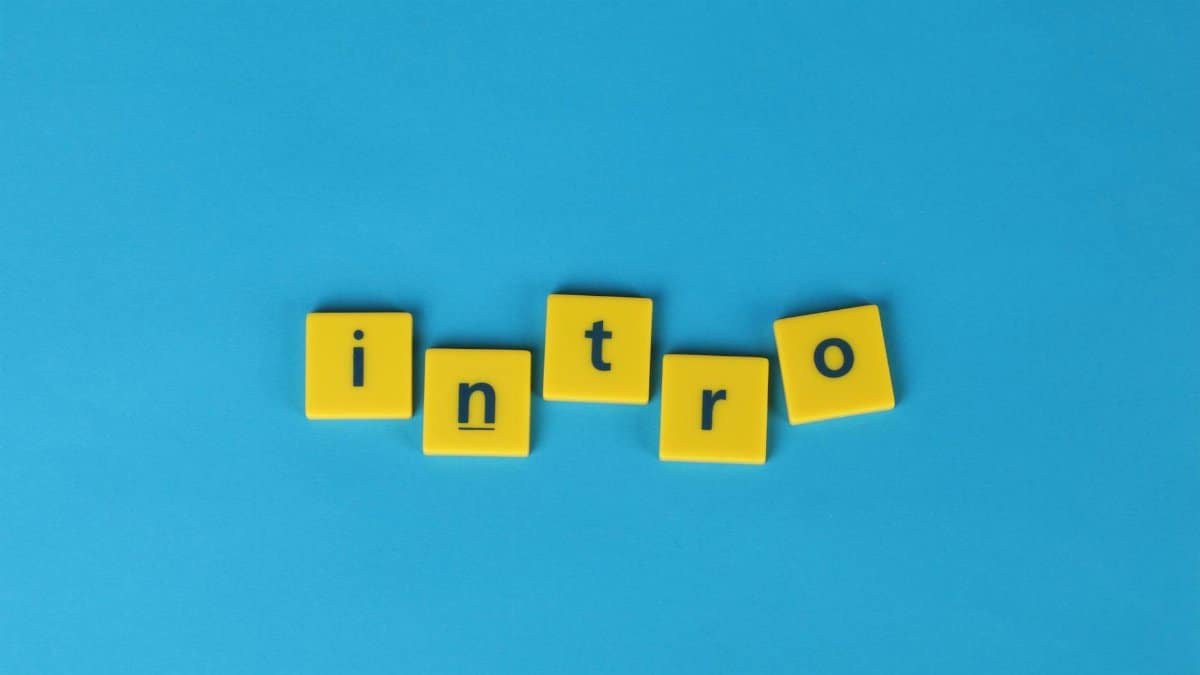Yellow letter tiles spell 'intro' on a vibrant blue background, ideal for creative projects.