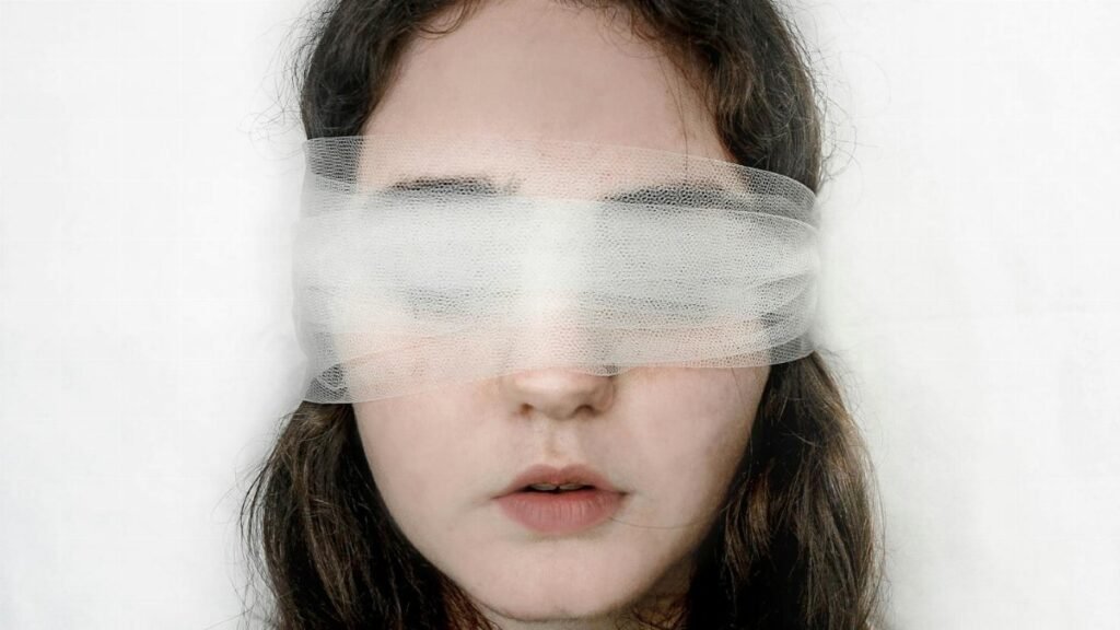 Close-up of a blindfolded woman with a serene expression, exploring themes of introspection.