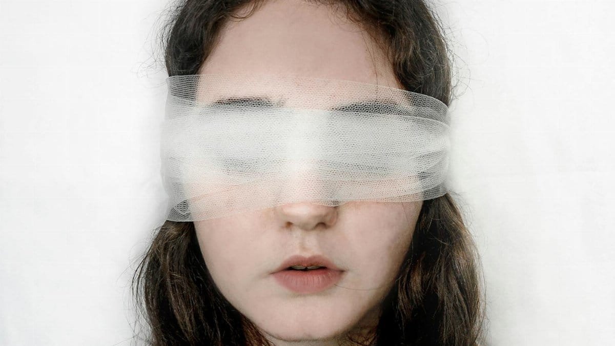 Close-up of a blindfolded woman with a serene expression, exploring themes of introspection.