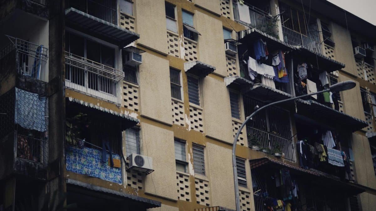 Close-up of an urban residential building facade with clothes hanging on balconies.