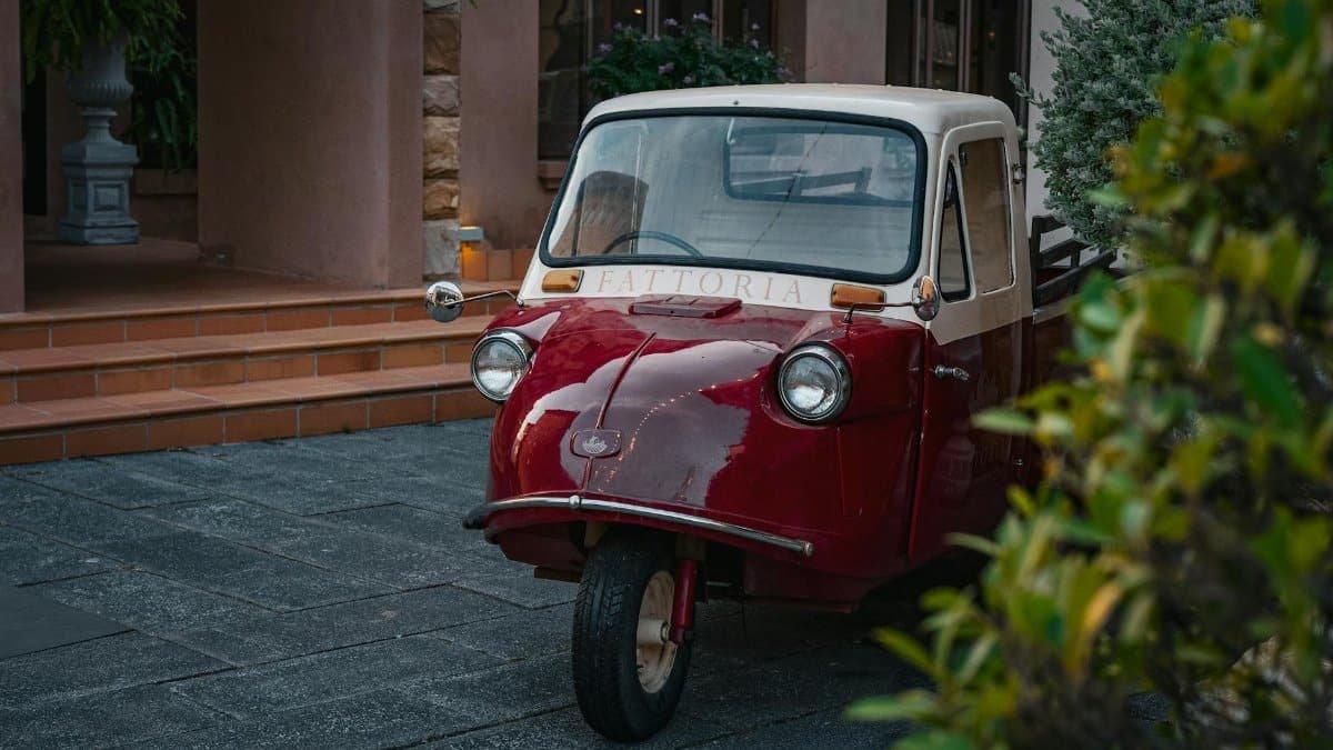 Charming retro three-wheeled vehicle in Thailand, captured outdoors in a serene setting.