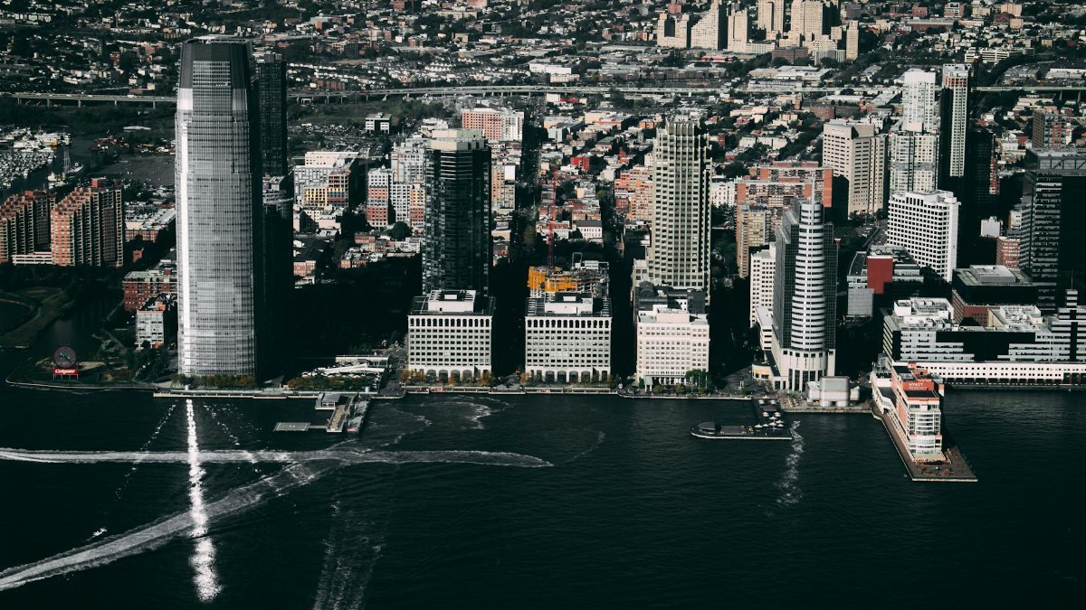 Dramatic aerial view of the Jersey City skyline showcasing prominent skyscrapers along the Hudson River.
