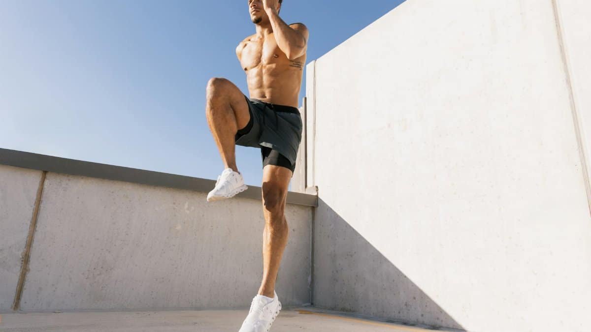 Male athlete doing cardio workout on a rooftop under blue sky in Austin, Texas.
