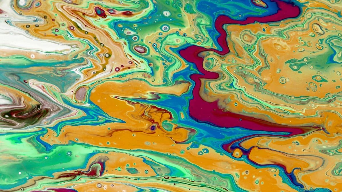 Colorful abstract paint flow resembling a natural landscape or map.
