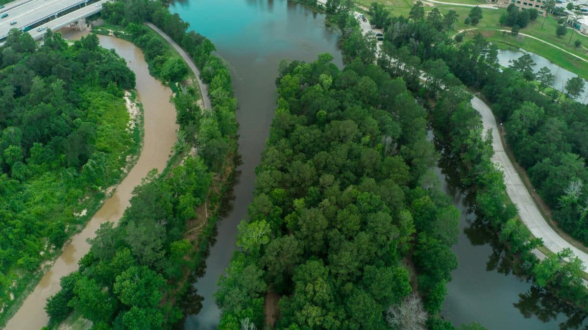 Captivating aerial shot of lush green rivers and urban landscape in Houston, TX during summer.