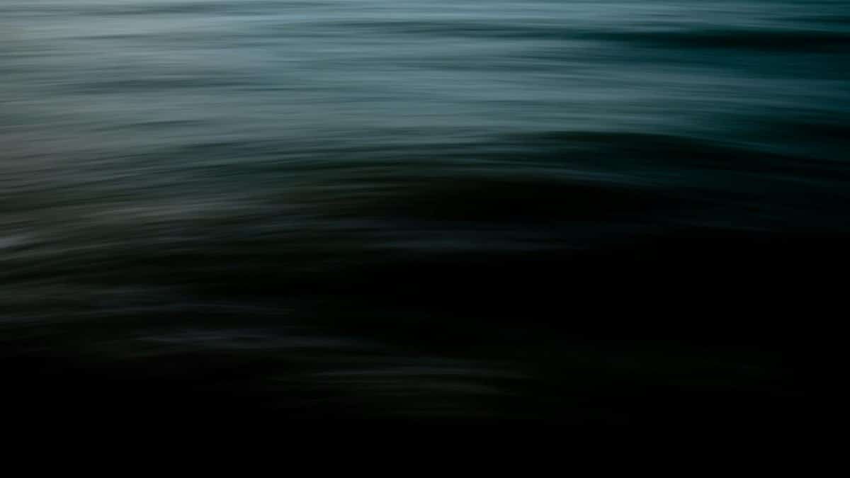 Abstract image of dark water with motion blur creating a calm yet dramatic effect.