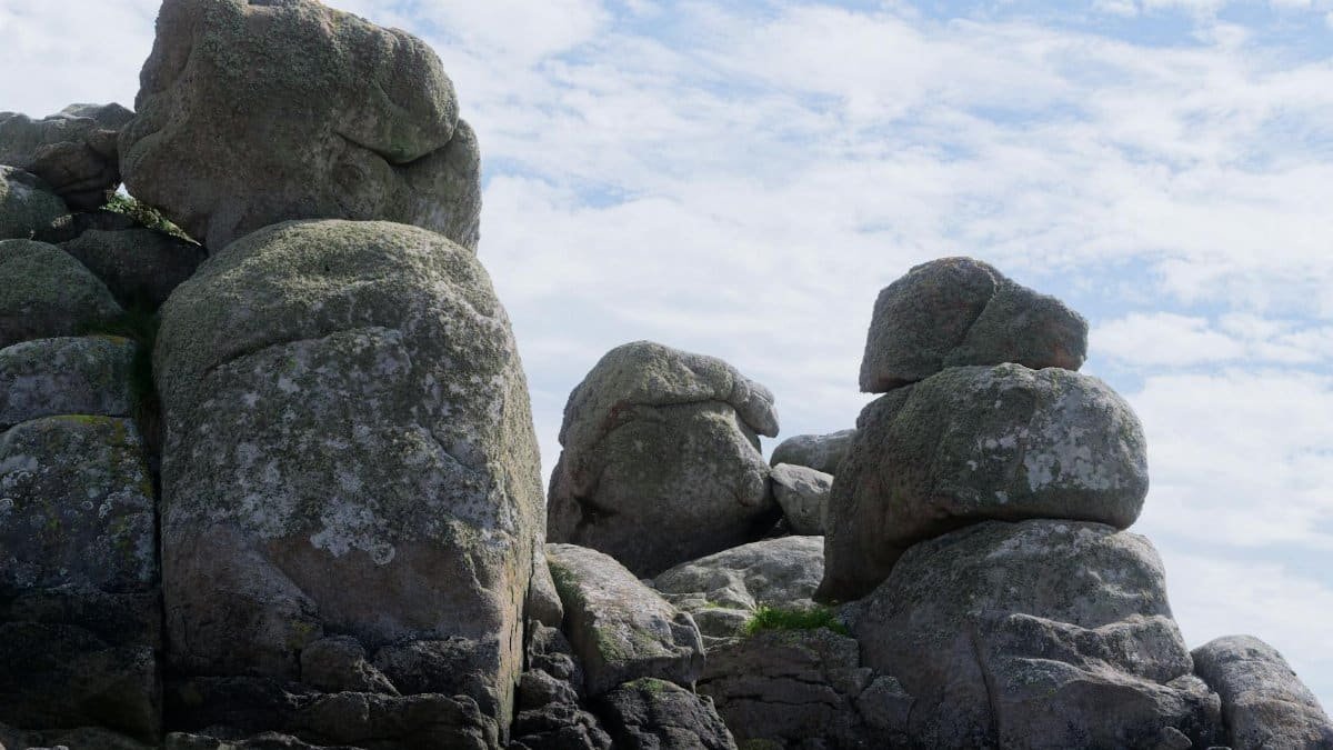 Scenic view of stacked rocks forming a natural monument under a blue, cloudy sky.