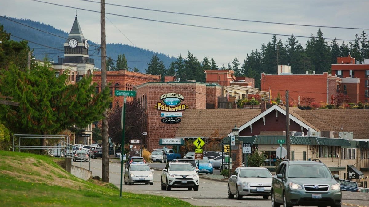 Street view of the historic Fairhaven district in Bellingham, WA with vibrant architecture and traffic.