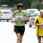 Adult and senior runners participating in an urban marathon race, showcasing endurance and fitness.