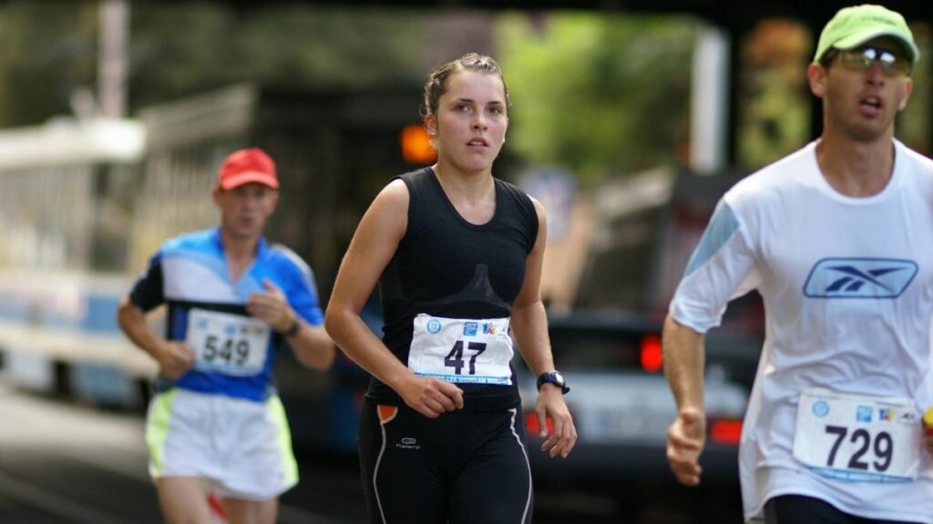 Competitive runners focused during a marathon in Wrocław city streets.