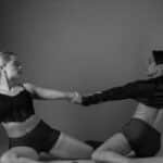 Black and white artistic photo capturing a couple performing contemporary dance in an elegant pose.