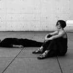 Artistic black and white image of two people in a modern architectural setting in Berlin.