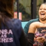 Two women sharing a moment of laughter outdoors in Ciudad de México, showcasing happiness and friendship.