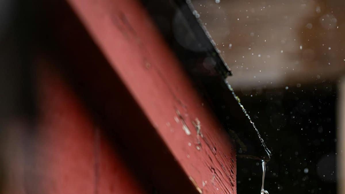 Raindrop dripping from a red roof in Canonsburg, PA. Captures essence of rainy fall day.