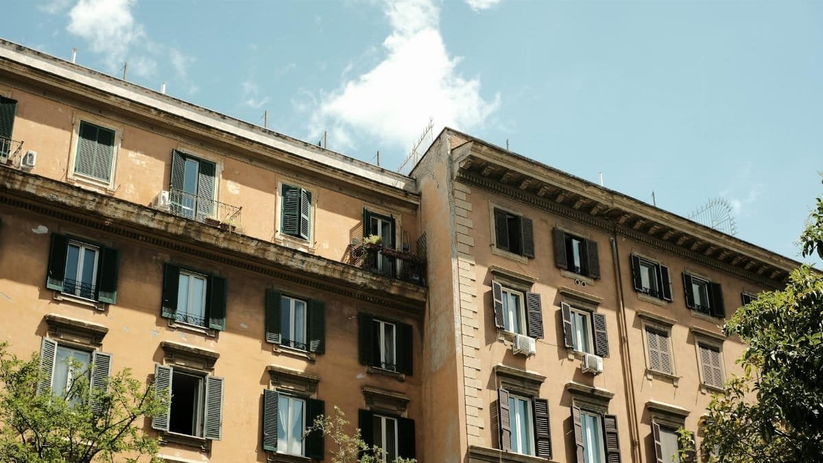 Charming view of historic apartment buildings under clear skies in Rome, Italy.