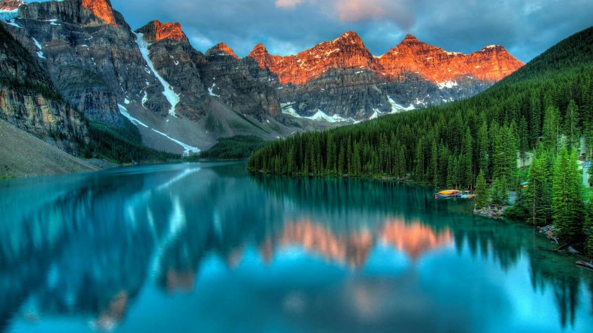 Capture the serene beauty of Moraine Lake with sunrise reflections in Banff National Park.