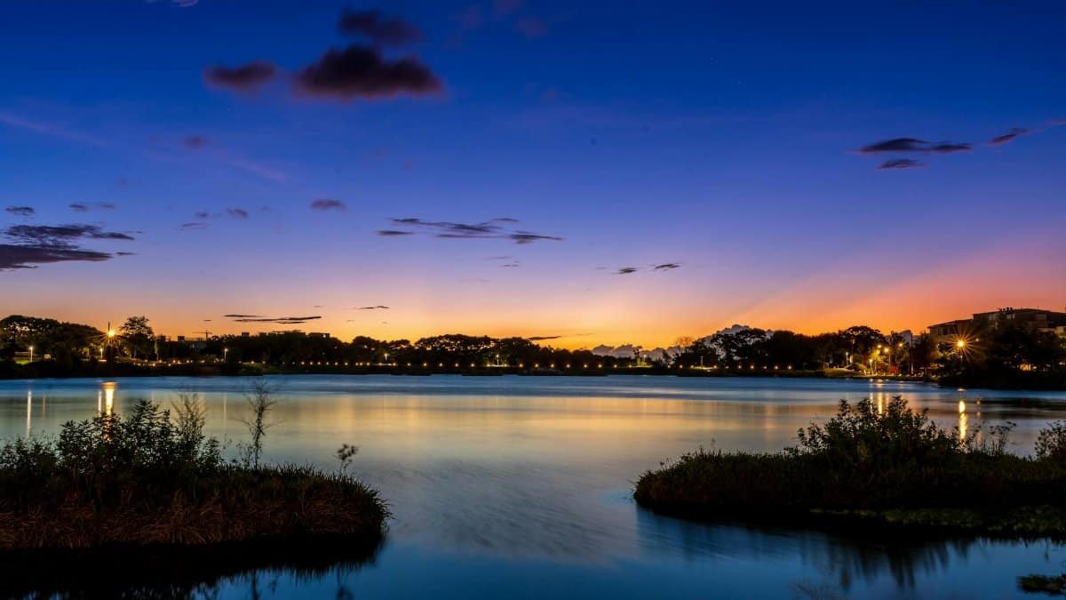 A stunning twilight view over a calm lakeside with vibrant colors in the sky.
