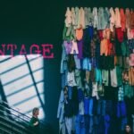 A vibrant display of assorted vintage clothes on a showroom wall inside a retail store.