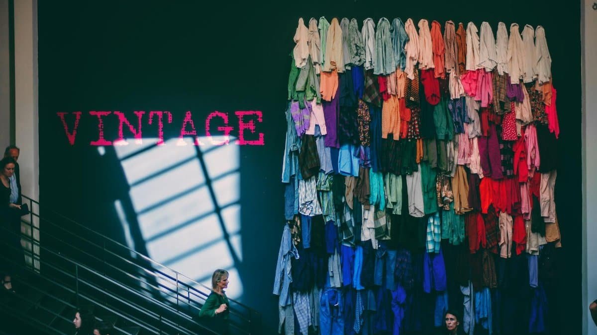 A vibrant display of assorted vintage clothes on a showroom wall inside a retail store.