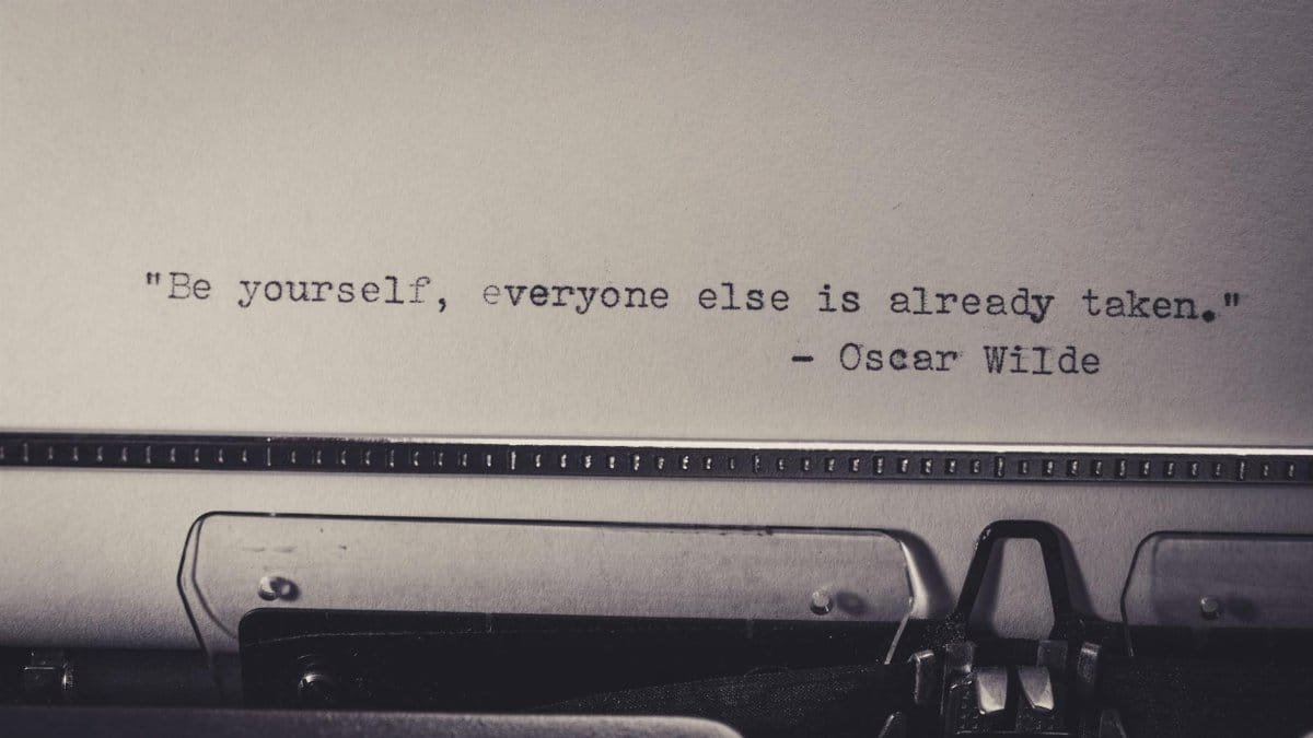 Vintage typewriter displaying Oscar Wilde's quote 'Be yourself, everyone else is already taken.'