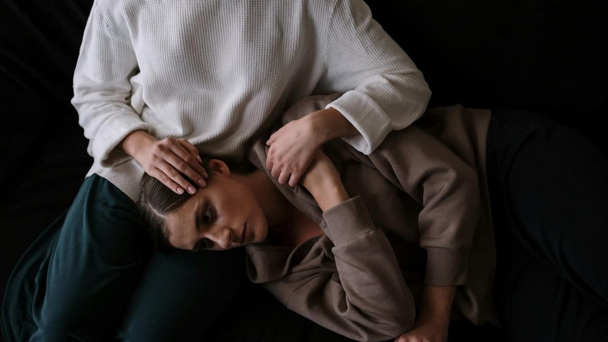 Two people share an intimate moment, symbolizing comfort and emotional support.