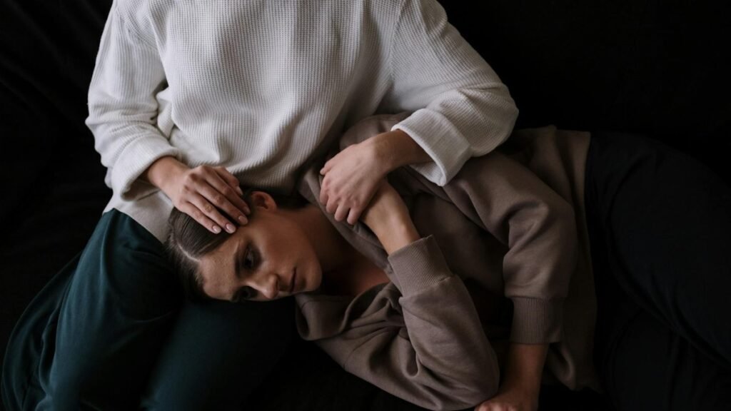 Two people share an intimate moment, symbolizing comfort and emotional support.