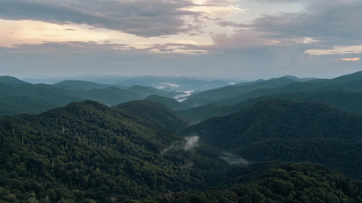 A breathtaking aerial view of the misty Great Smoky Mountains at sunrise in Gatlinburg, Tennessee.