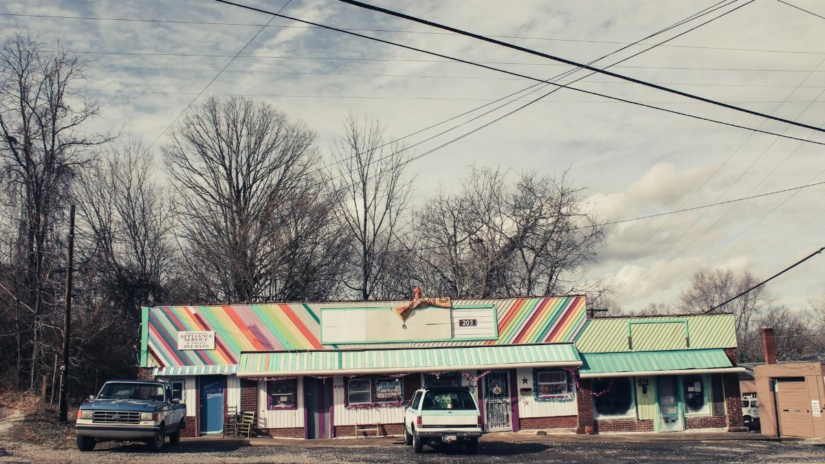 Vibrant storefront with vehicles and power lines in Asheville, NC